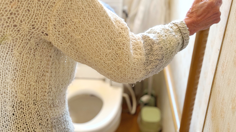 お手洗いに入ろうとするシニア女性